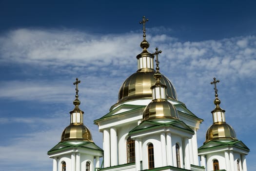 Orthodox church in beams of a bright sun against the blue sky