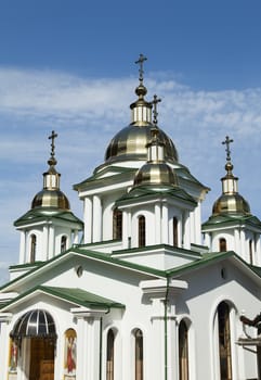 Orthodox church in beams of a bright sun against the blue sky