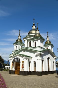 Orthodox church in beams of a bright sun against the blue sky