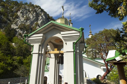 Orthodox church in beams of a bright sun against the blue sky