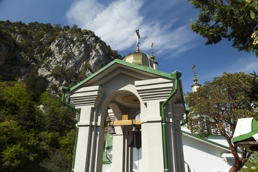 Orthodox church in beams of a bright sun against the blue sky