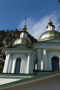 Orthodox church in beams of a bright sun against the blue sky