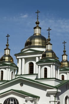 Orthodox church in beams of a bright sun against the blue sky