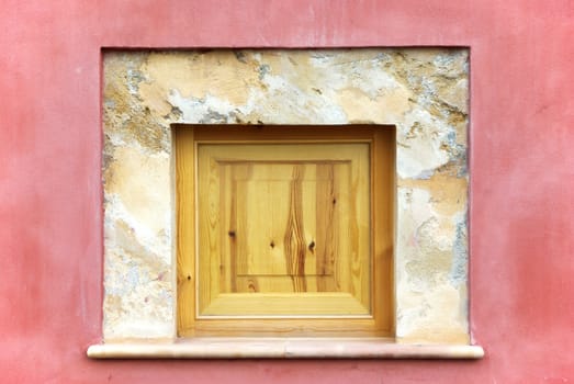 Detail of a Wooden Window on an old pink wall