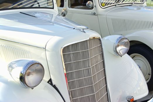 Details of two Classical white cars