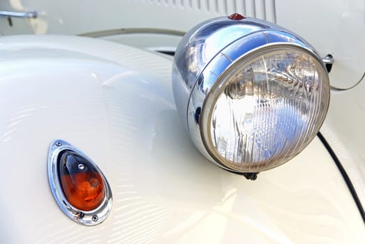 Details of the headlights of a Classical White Car