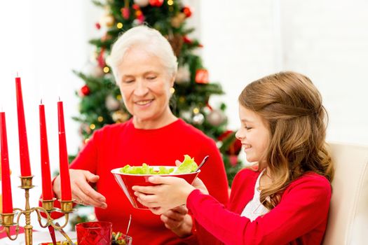 family, holidays, generation, christmas and people concept - smiling family having dinner at home