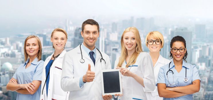 medicine, technology and healthcare concept - team or group of doctors and nurses with tablet pc computer blank screen showing thumbs up