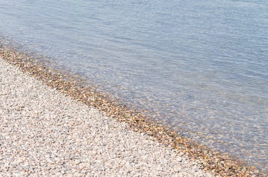 Beautiful waterside scenery with little stones on a river.