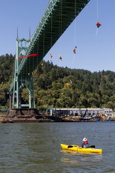 PORTLAND, OREGON - JULY 29, 2015: Greenpeace USA activists rappelled off St Johns Bridge in Portland Oregon in protest and preventing the Shell Oil Icebreaker Vessel from leaving for oil drilling in the Arctic with one kayaktivist on Willamette River