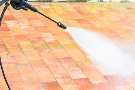 Outdoor floor cleaning and building cleaning with high pressure water jet.