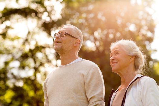 family, age, tourism, travel and people concept - senior couple in park