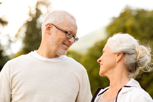 family, age, tourism, travel and people concept - senior couple in city park