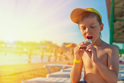 Baby boy with ice-cream at the beach