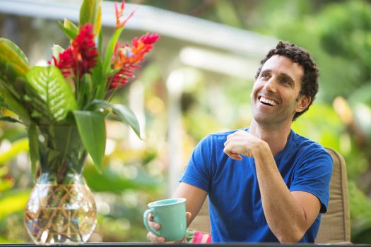 Single man with mug smiling looking up