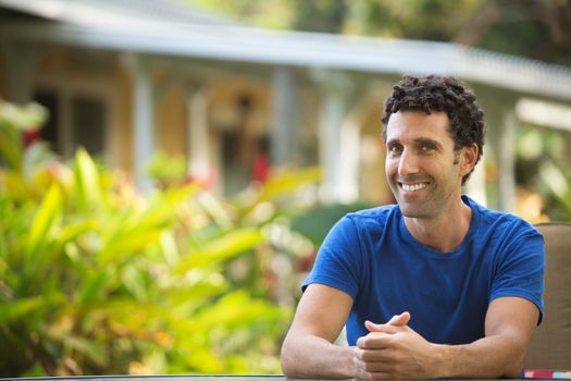 Adult man with smile and folded hands