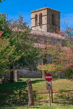 landscape of church with trees and green field