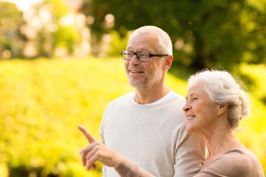 family, age, tourism, travel and people concept - senior couple in park