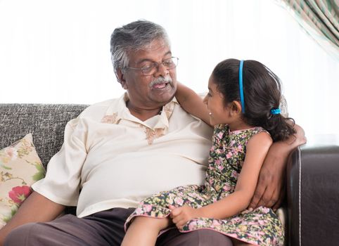 Portrait of Indian family at home. Grandparent and grandchild chatting. Asian people living lifestyle. Grandfather and granddaughter.