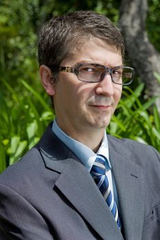 handsome businessman with glasses outdoors