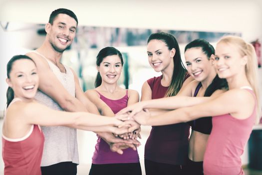 fitness, sport, training, gym, success and lifestyle concept - group of happy people in the gym celebrating victory