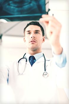 picture of male doctor or dentist looking at x-ray