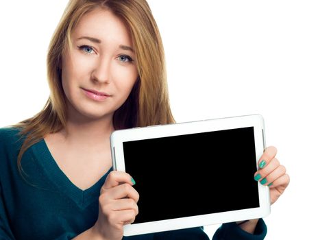 Young cheerful woman is showing blank tablet, isolated over white