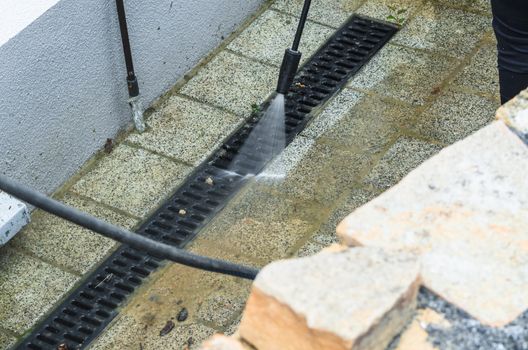 Outdoor floor cleaning and building cleaning with high pressure water jet.