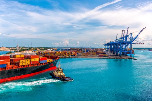  CONTAINER PORT OF FREEPORT GRAND BAHAMAS ISLAND - OCT., 8, 2014: Container ship delivers cargo to the port.