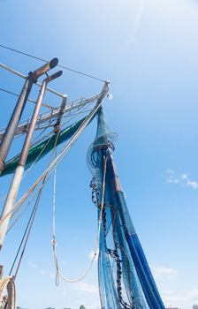 Fishing nets hanging from boats mast  drying in sun at Yamba, Queensland Australia.