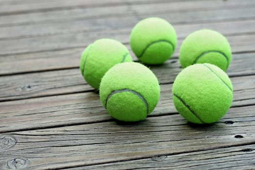 pile of tennis ball  on wooden background