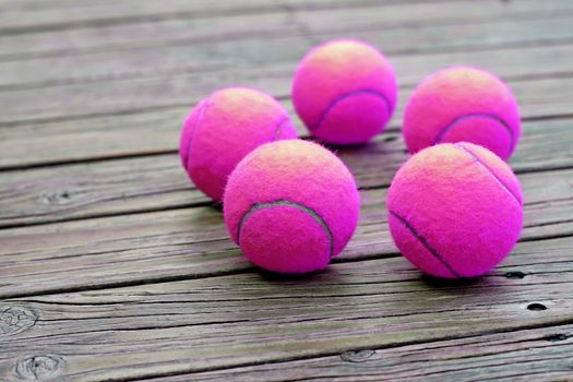 exotic purple tennis ball  on wooden background