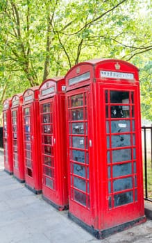 Row of red phone booth in London.