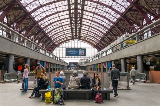 Antwerp, Belgium - May 11, 2015: People in Main hall of Antwerp Central station on May 11, 2015 in Antwerp, Belgium. The station is now widely regarded as the finest example of railway architecture in Belgium.