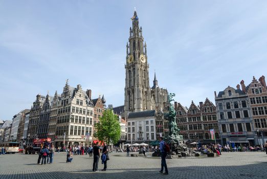 Antwerp, Belgium - May 10, 2015: Tourist visit The Grand Place with the Statue of Brabo, throwing the giant's hand into the Scheldt River and the Cathedral of our Lady. on May 10, 2015 in Antwerp, Belgium.