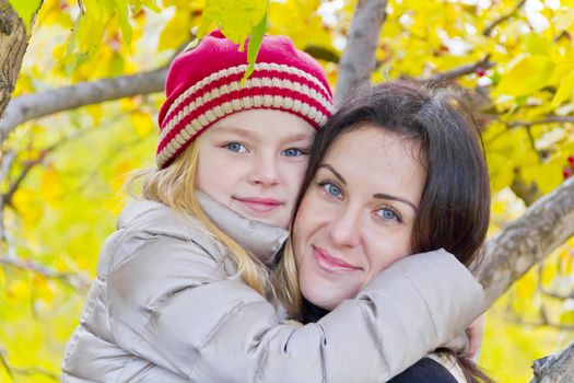 Portrait of happy mother and daughter in autumn