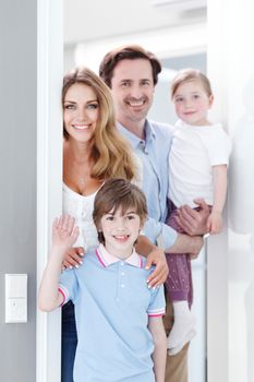 happy family standing inside their new house