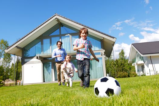 family playing football in front of their house