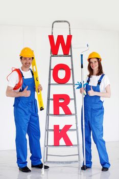 two workers in front of ladder with word work