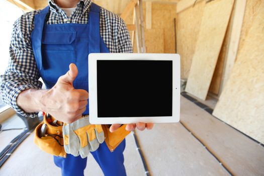 close-up of worker with tablet and thumbs up