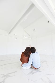 young couple sitting in a new house