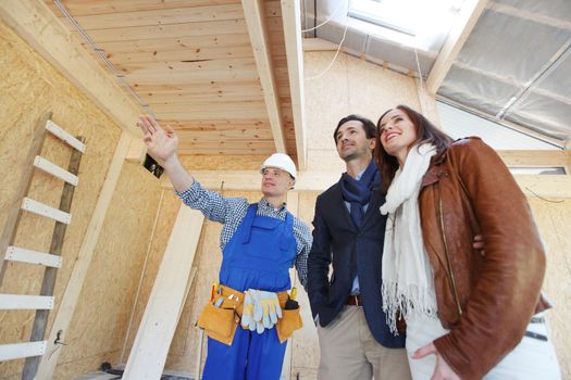 foreman shows new house to a young couple