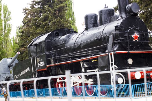 The engine as a monument costs in the middle of the city and reminds passersby of the past