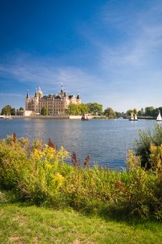 Schwerin Castle (Schweriner Schloss) reflected in the lake with some sailing boats