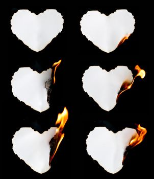 heart shape paper burning on black background