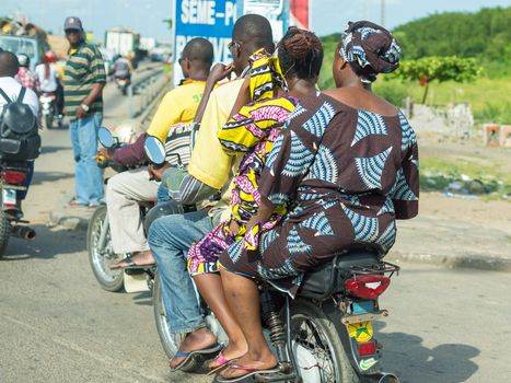 Cotonou, Benin: May 26:  People hire motorcycle taxis to move around in the city of Benin, one of the most common means of hired transportation in the city, on May 26, 2015 in Cotonou, Benin.