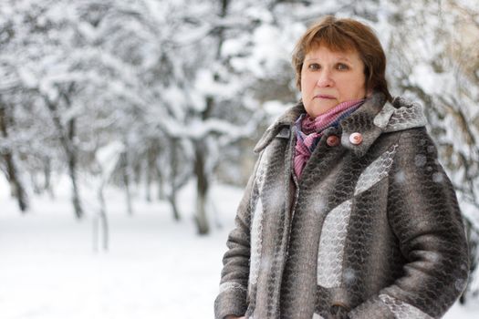 Portrait of  mature woman in winter park