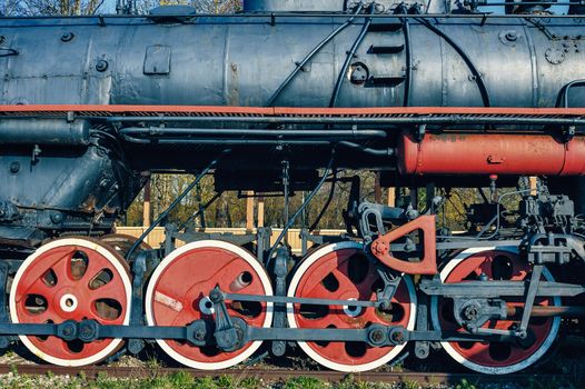Profile of vintage steam locomotive on a pedestal