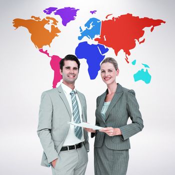 Business people looking at camera against grey background