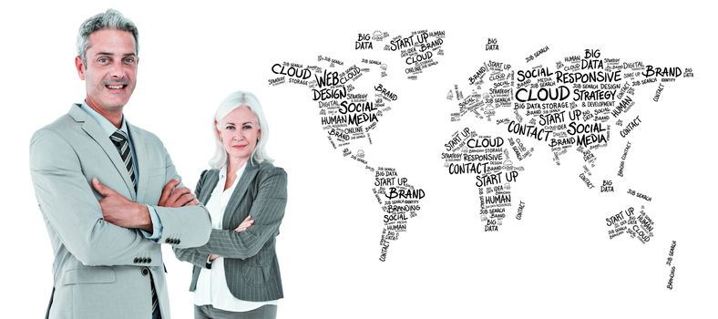  Smiling businesswoman and man with arms crossed against world map of buzzwords